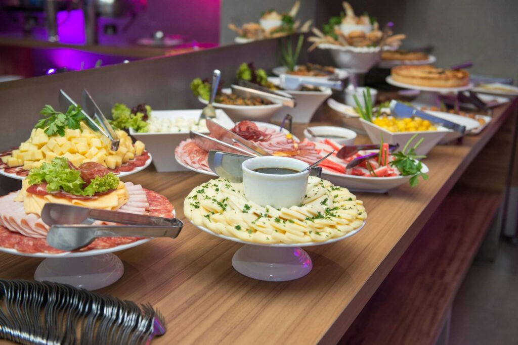 A variety of gourmet dishes displayed on a catering table, part of a full-service catering event in Houten.